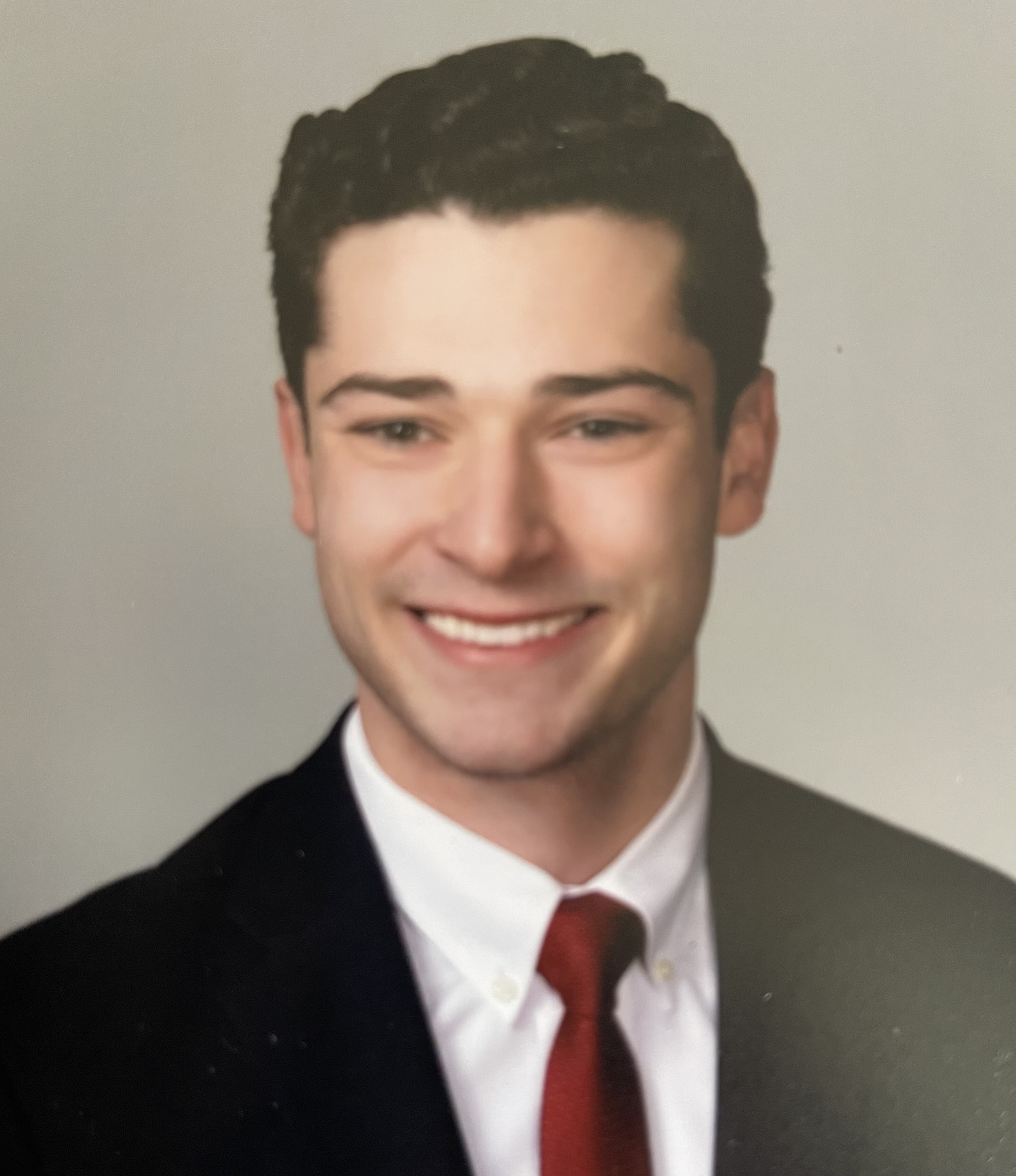 man in coat and tie in a posed photograph