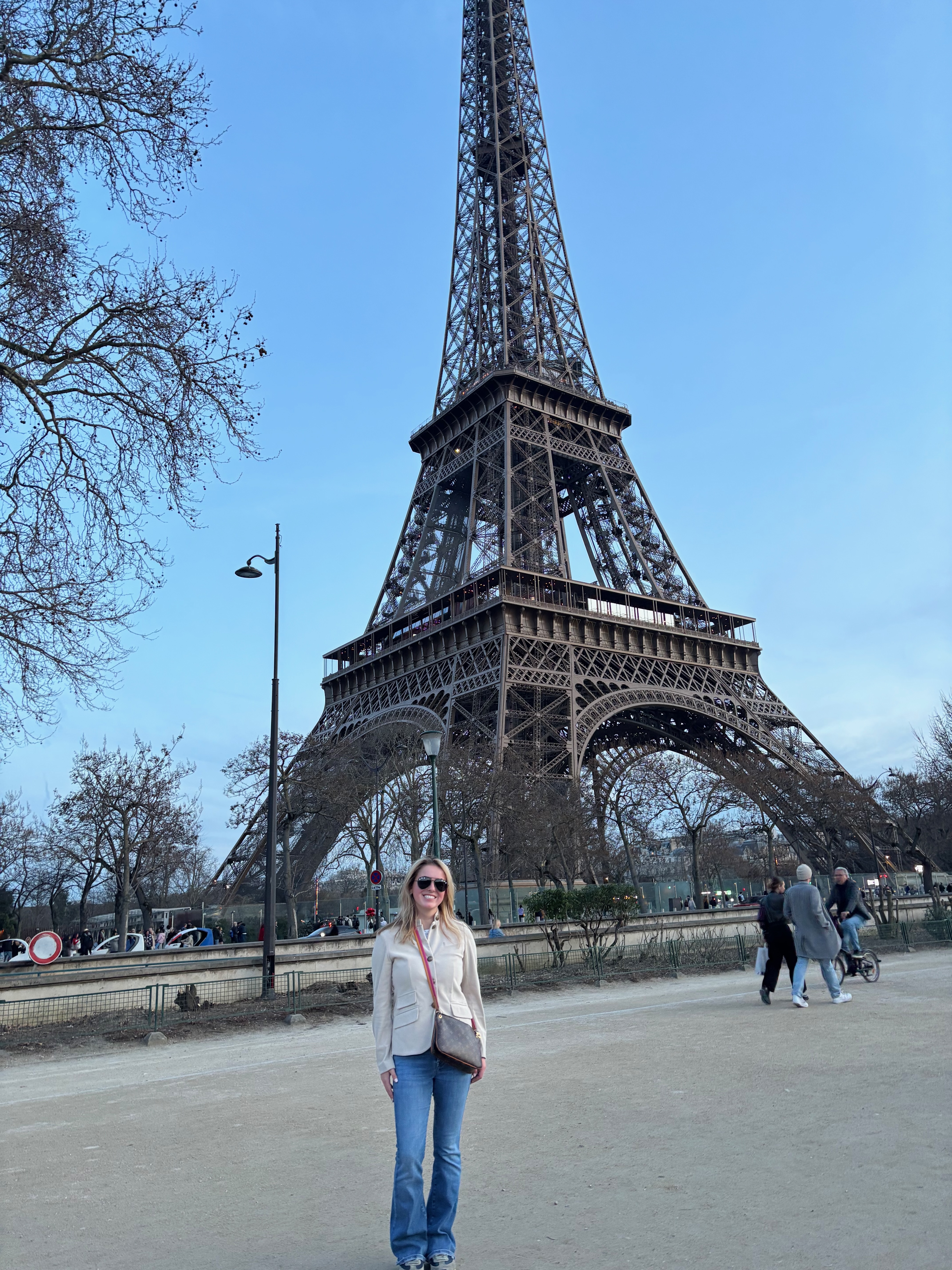 woman standing in front of the Eiffel Tower in Paris